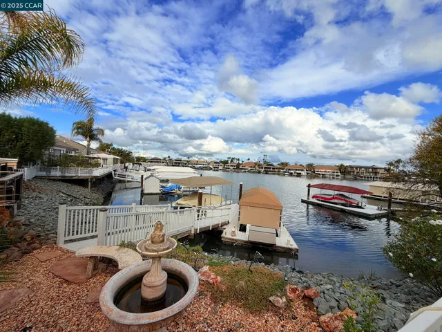 a view of a terrace with lawn chairs