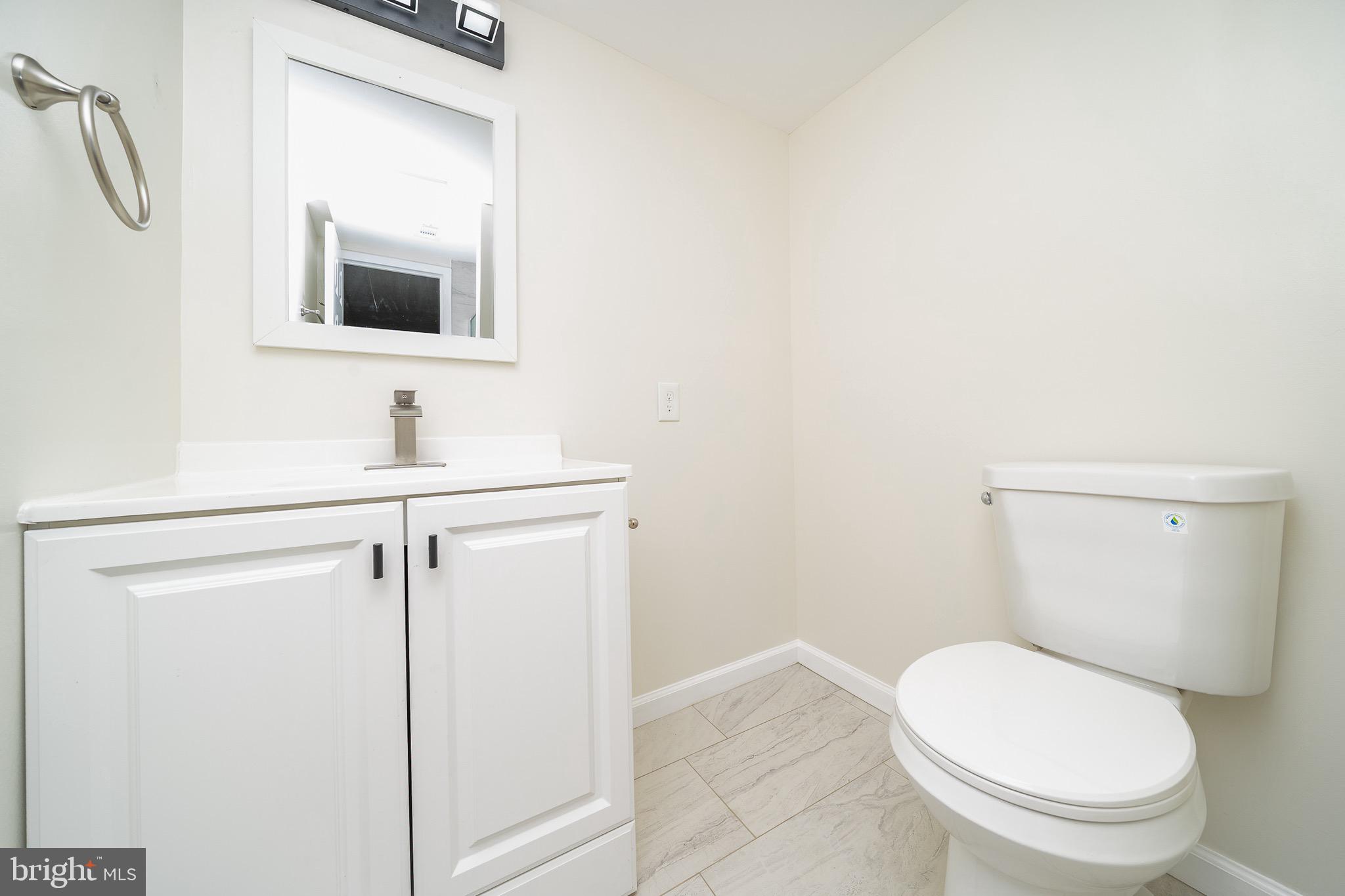9910 Walker House Road, Unit 99104 Gaithersburg, MD 20886 - Photo 21 of 32 a white toilet sitting next to a bathroom sink