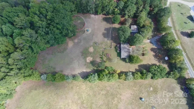 an aerial view of a house with a yard and garden