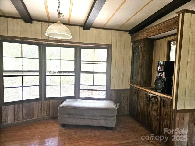 a spacious bedroom with a large bed and a large window