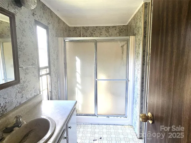 a bathroom with a granite countertop sink a toilet and shower
