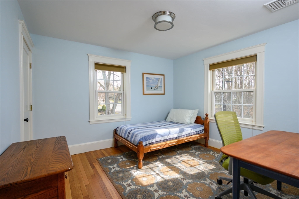 30 Ridge Road Milton, MA 02186 - Photo 22 of 33 a bedroom with a bed and a chair