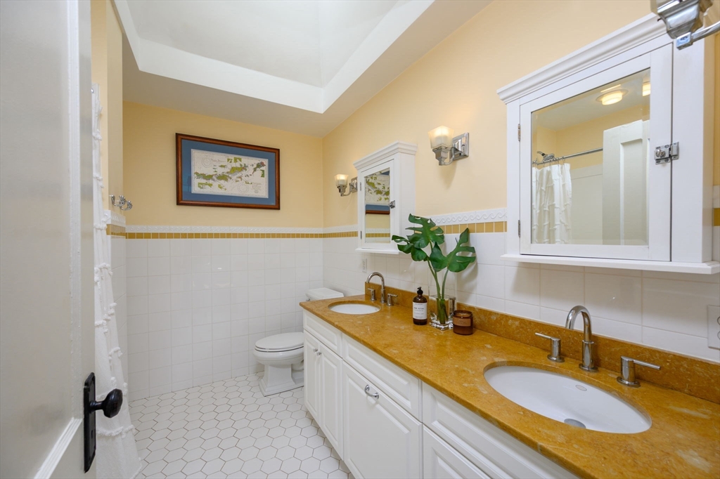 30 Ridge Road Milton, MA 02186 - Photo 24 of 33 a bathroom with a granite countertop sink and a mirror