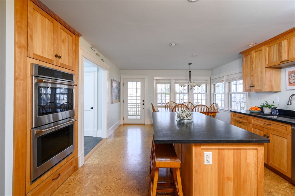 30 Ridge Road Milton, MA 02186 - Photo 9 of 33 a kitchen with stainless steel appliances granite countertop a stove a refrigerator a kitchen island a stove and a sink with granite countertops