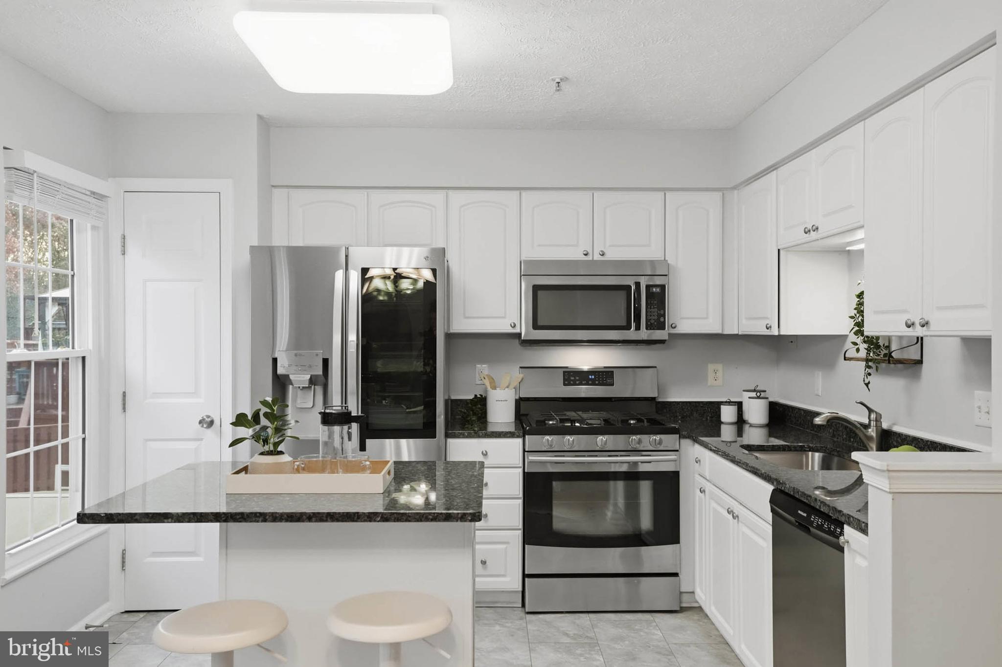 2512 Summers Ridge Drive Odenton, MD 21113 - Photo 11 of 37 a kitchen with granite countertop a sink stove and cabinets