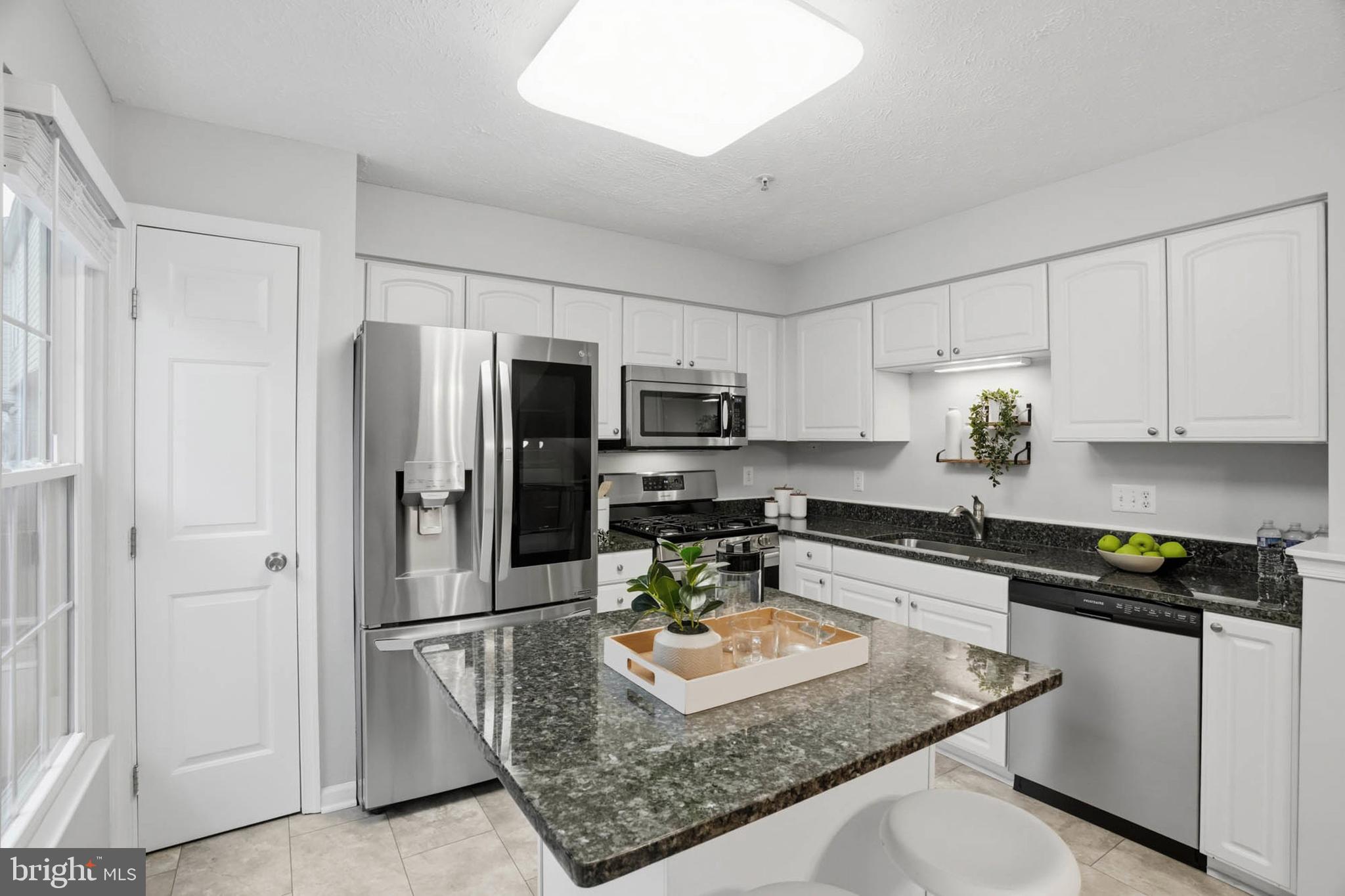 2512 Summers Ridge Drive Odenton, MD 21113 - Photo 11 of 37 a kitchen with stainless steel appliances granite countertop a refrigerator a stove a sink a stove and white cabinets