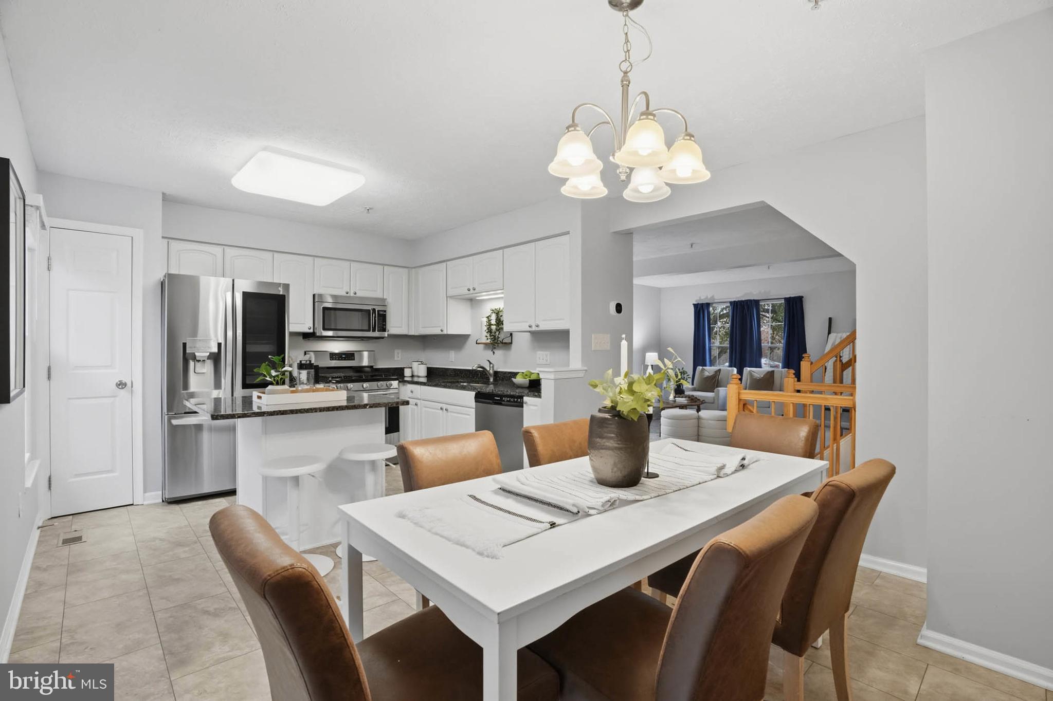 2512 Summers Ridge Drive Odenton, MD 21113 - Photo 12 of 37 a dining room filled with stainless steel appliances kitchen island granite countertop a dining table chairs and a refrigerator