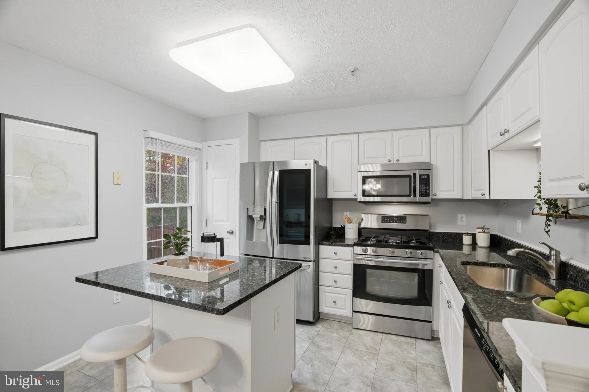 2512 Summers Ridge Drive Odenton, MD 21113 - Photo 9 of 37 a kitchen with stainless steel appliances a stove a sink a microwave and refrigerator