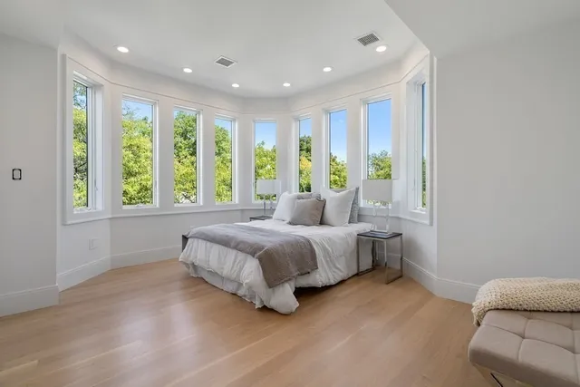 a bedroom with a bed and a large window