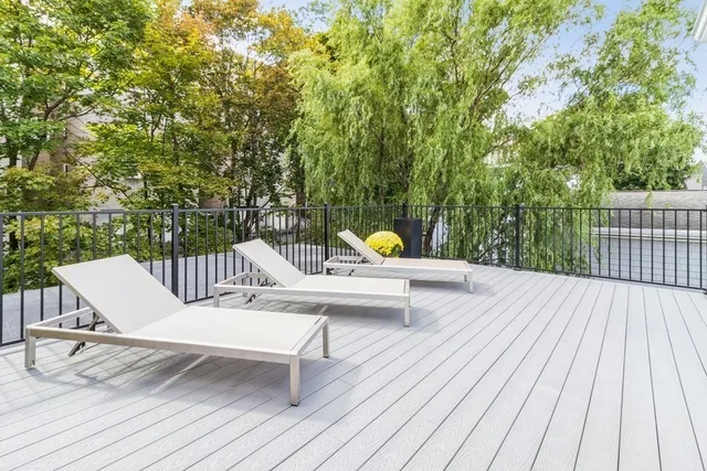 a view of a balcony with wooden floor and fence