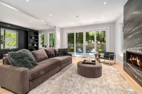 a living room with furniture a window and a fireplace