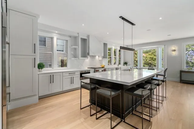 a kitchen with granite countertop a sink appliances and cabinets