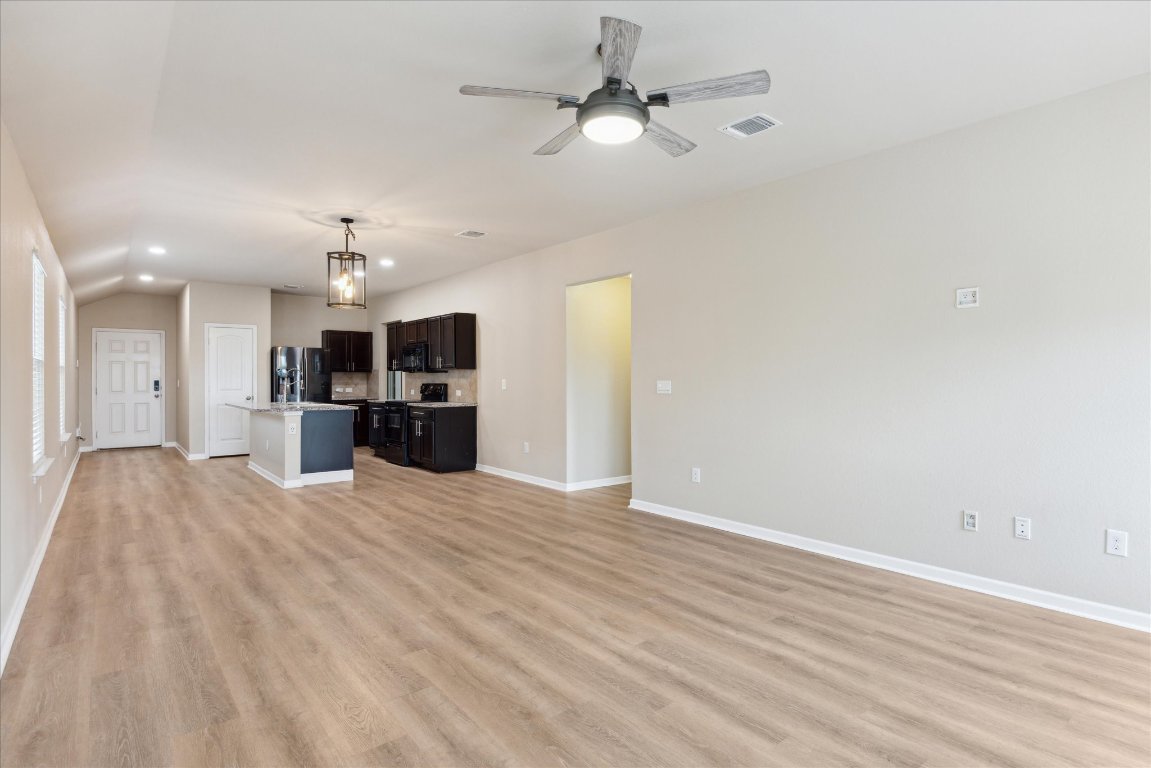 12003 Waterford Run Way Manor, TX 78653 - Photo 3 of 7 a view of a kitchen with a sink and a kitchen counter top