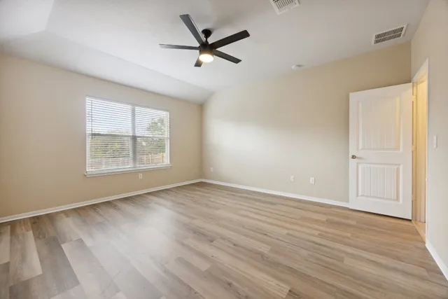 wooden floor in an empty room with a window