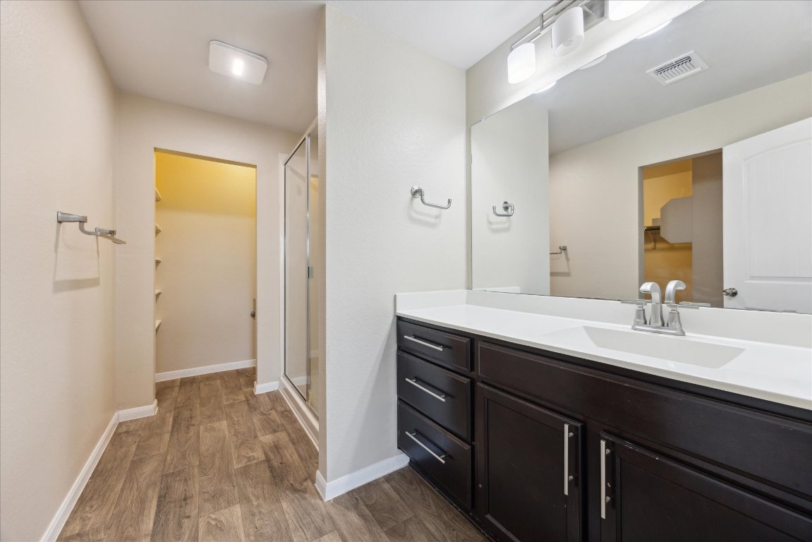 12003 Waterford Run Way Manor, TX 78653 - Photo 5 of 7 a en suite bathroom with a granite countertop sink and a mirror