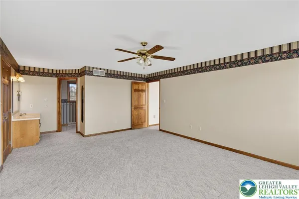 a view of a room with window and a ceiling fan