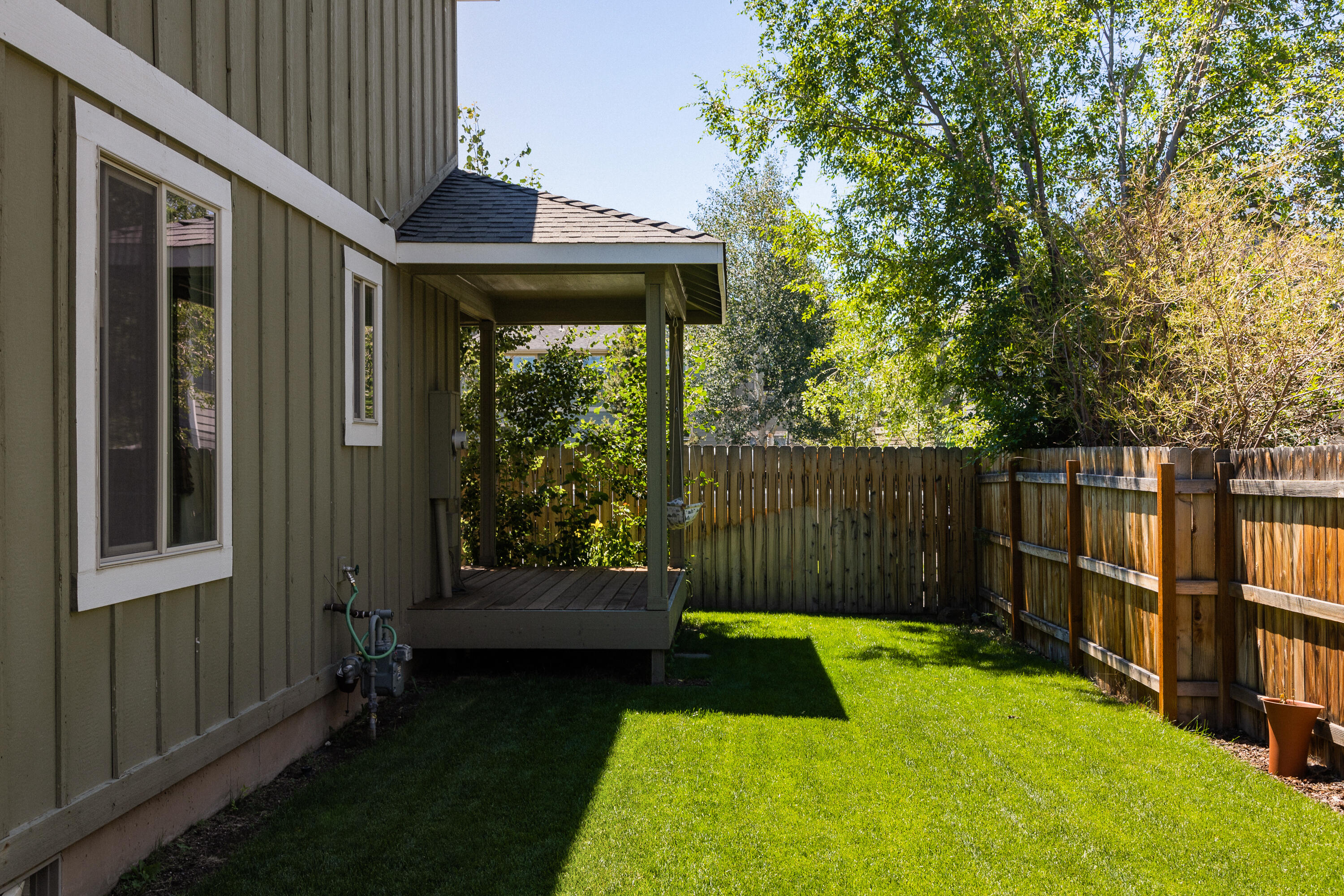 63591 Boyd Acres Road Bend, OR 97701 - Photo 19 of 19 a view of a backyard with large trees and wooden fence
