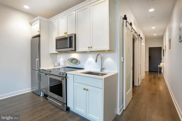 a kitchen with a stove and a refrigerator