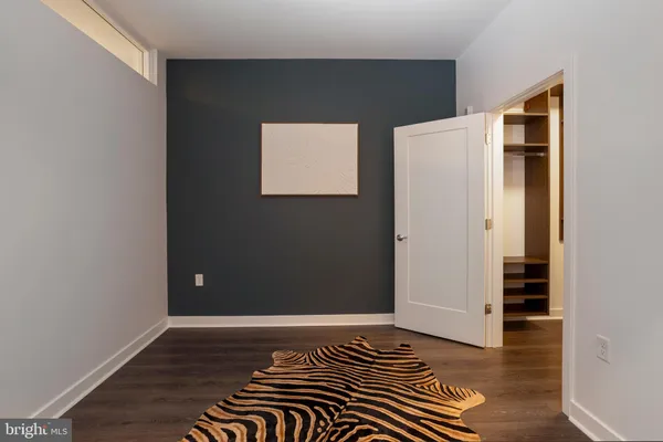 a view of walk in closet with empty racks