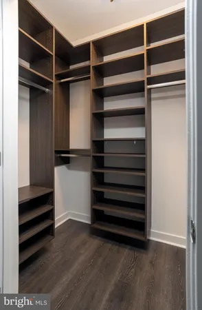 a bathroom with a toilet sink vanity and mirror
