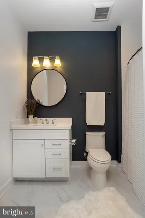 a bathroom with a toilet sink and mirror