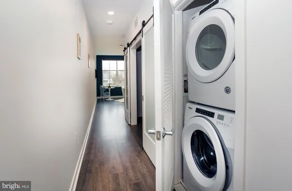 a view of a hallway with wooden shelves