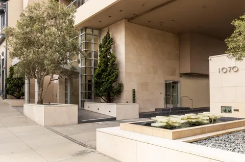 a view of a patio with couches and potted plants