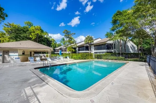 a view of a house with swimming pool and sitting area