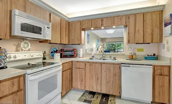 a kitchen with a sink cabinets and window