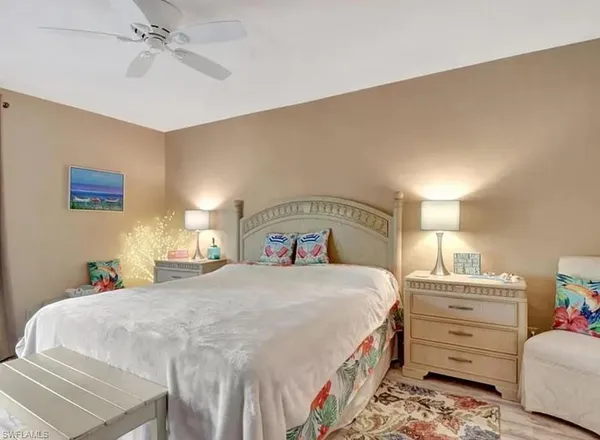 a bedroom with a bed and a lamp