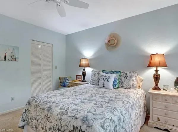 a bedroom with a bed and a lamp on table