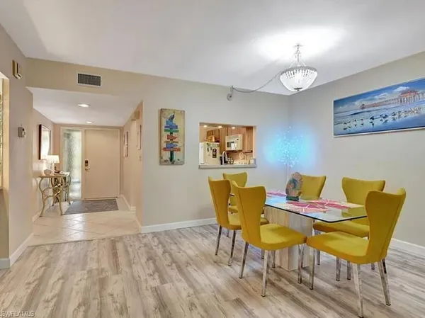 a view of a dining room with furniture and wooden floor