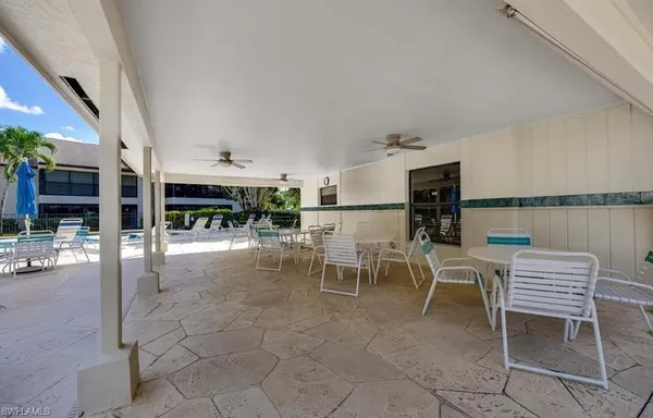 a view of a kitchen with dining table and chairs