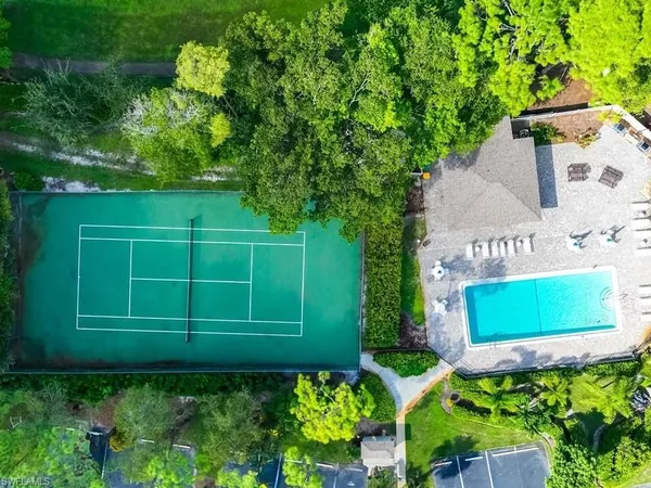 a green field with trees in the background