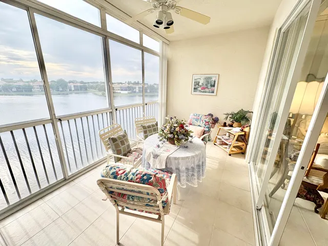 a living room with furniture and floor to ceiling windows