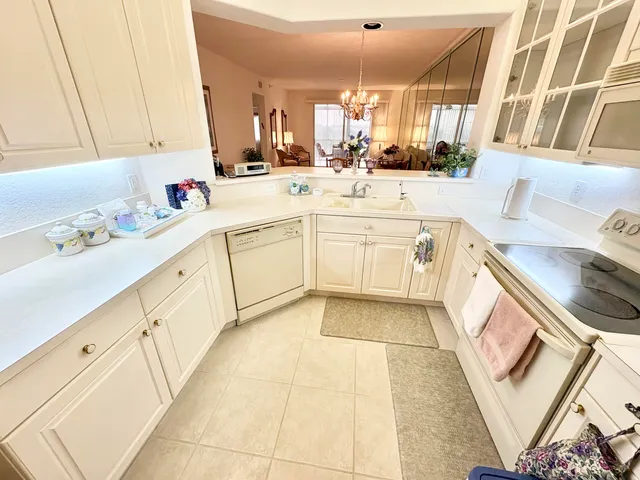 a kitchen with a sink cabinets and window