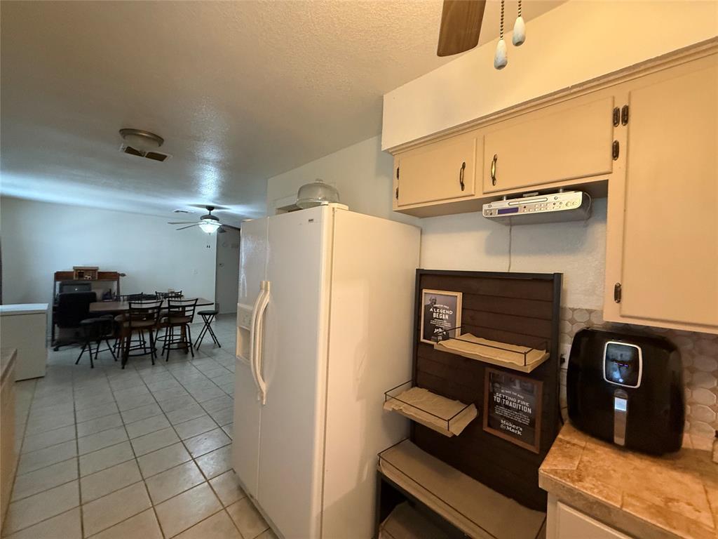 58 Roberts Road Mineral Wells, TX 76067 - Photo 13 of 28 a view of kitchen with furniture and a refrigerator