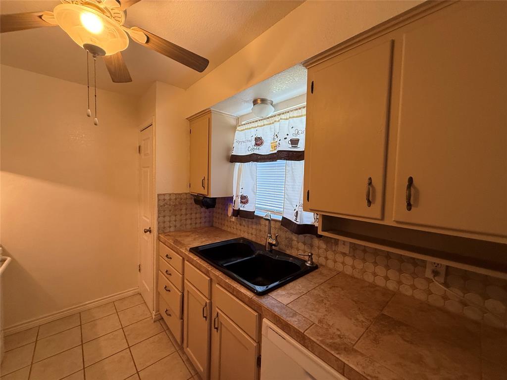 58 Roberts Road Mineral Wells, TX 76067 - Photo 14 of 28 a kitchen with a sink and cabinets