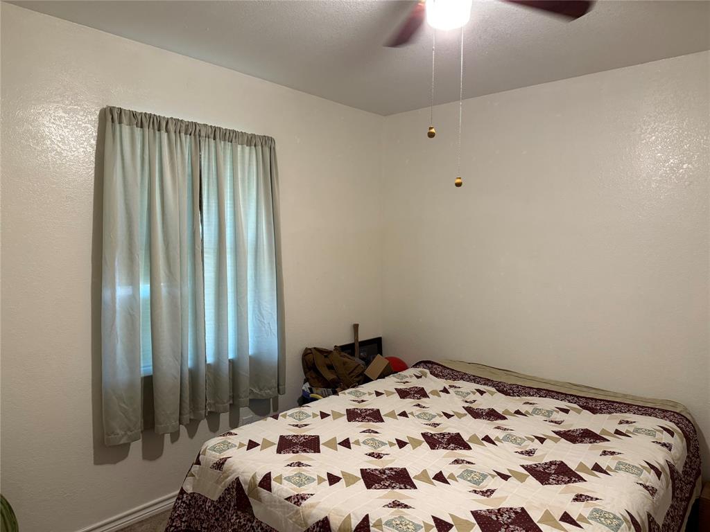 58 Roberts Road Mineral Wells, TX 76067 - Photo 19 of 28 a bedroom with a bed and a window