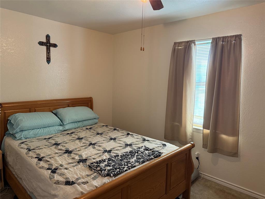 58 Roberts Road Mineral Wells, TX 76067 - Photo 20 of 28 a bedroom with a bed and a window