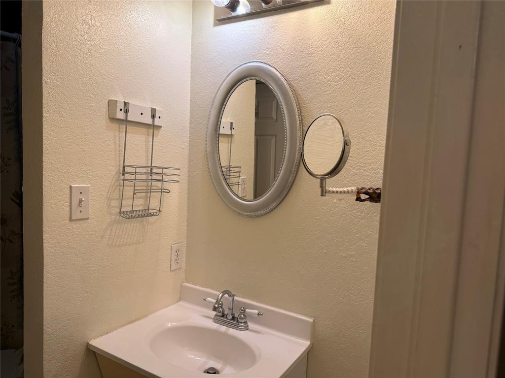 58 Roberts Road Mineral Wells, TX 76067 - Photo 21 of 28 a bathroom with a sink and a mirror