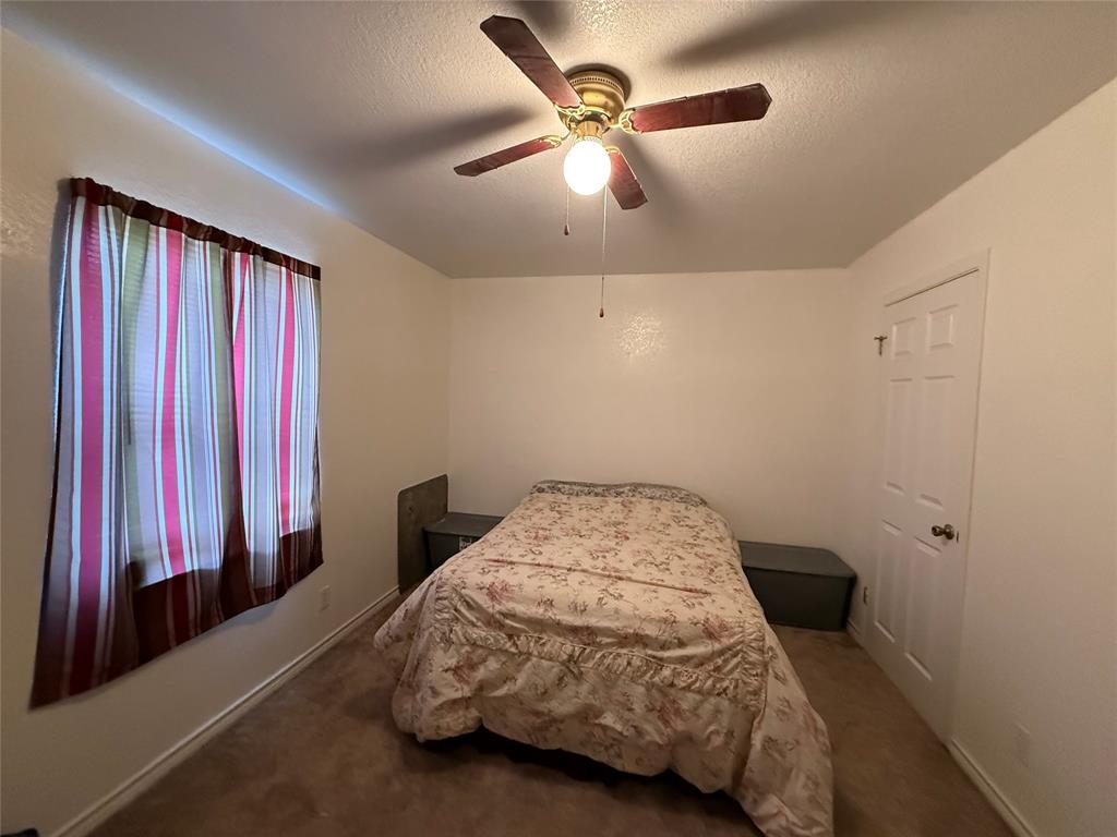 58 Roberts Road Mineral Wells, TX 76067 - Photo 25 of 28 a bedroom with a bed and a chandelier