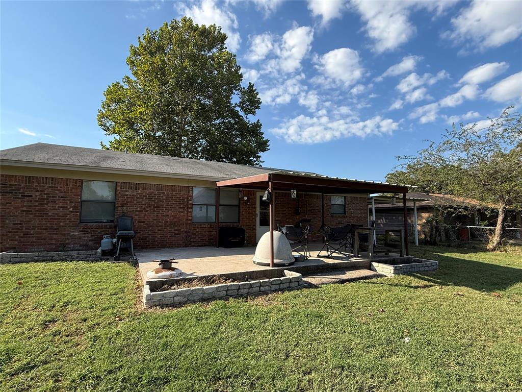 58 Roberts Road Mineral Wells, TX 76067 - Photo 27 of 28 a view of a house with backyard and sitting area