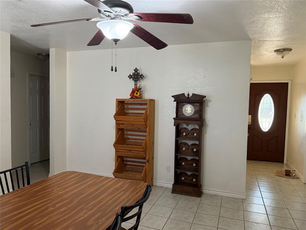 58 Roberts Road Mineral Wells, TX 76067 - Photo 7 of 28 a view of a room with shelves and wooden floor