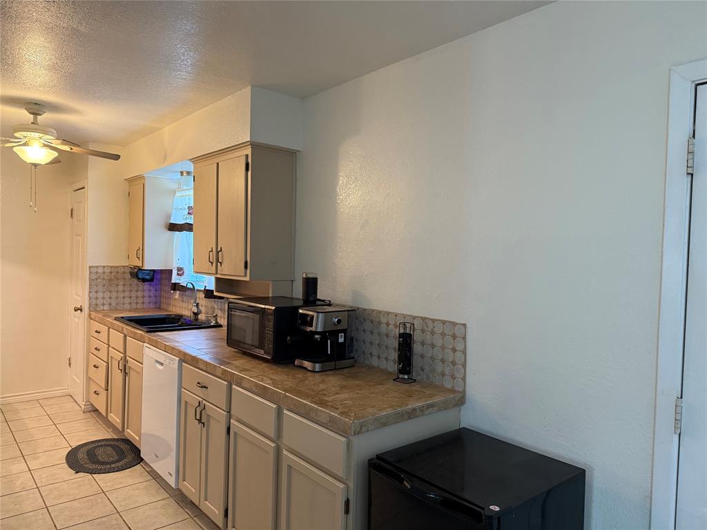 58 Roberts Road Mineral Wells, TX 76067 - Photo 9 of 28 a utility room with sink dryer and washer