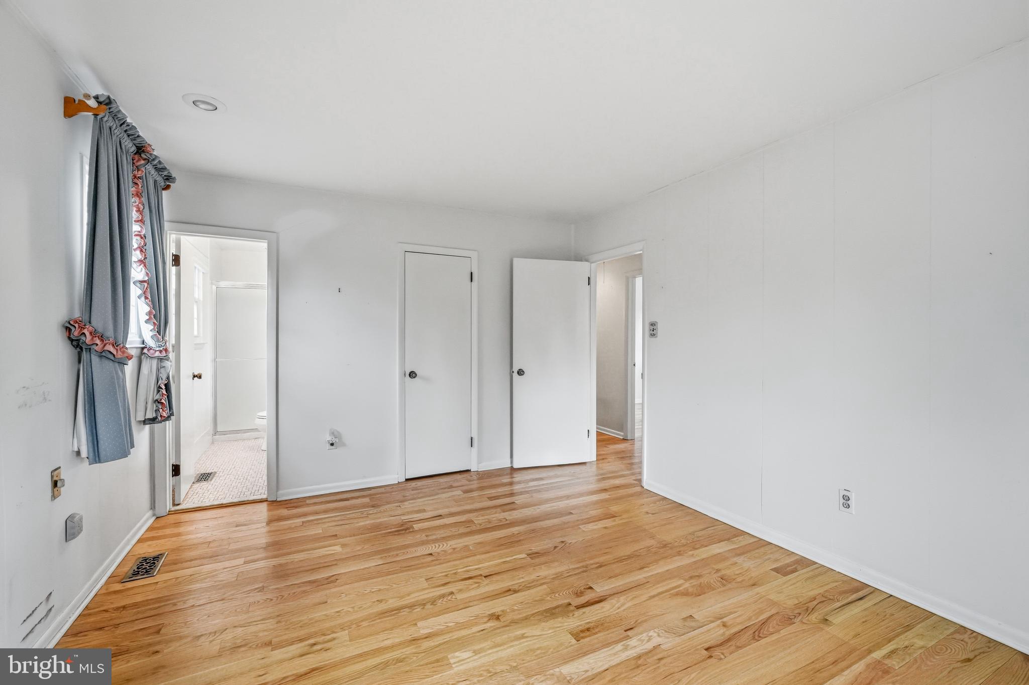 2 Winding Way Berlin, NJ 08009 - Photo 22 of 31 a view of an empty room with wooden floor and a bathroom