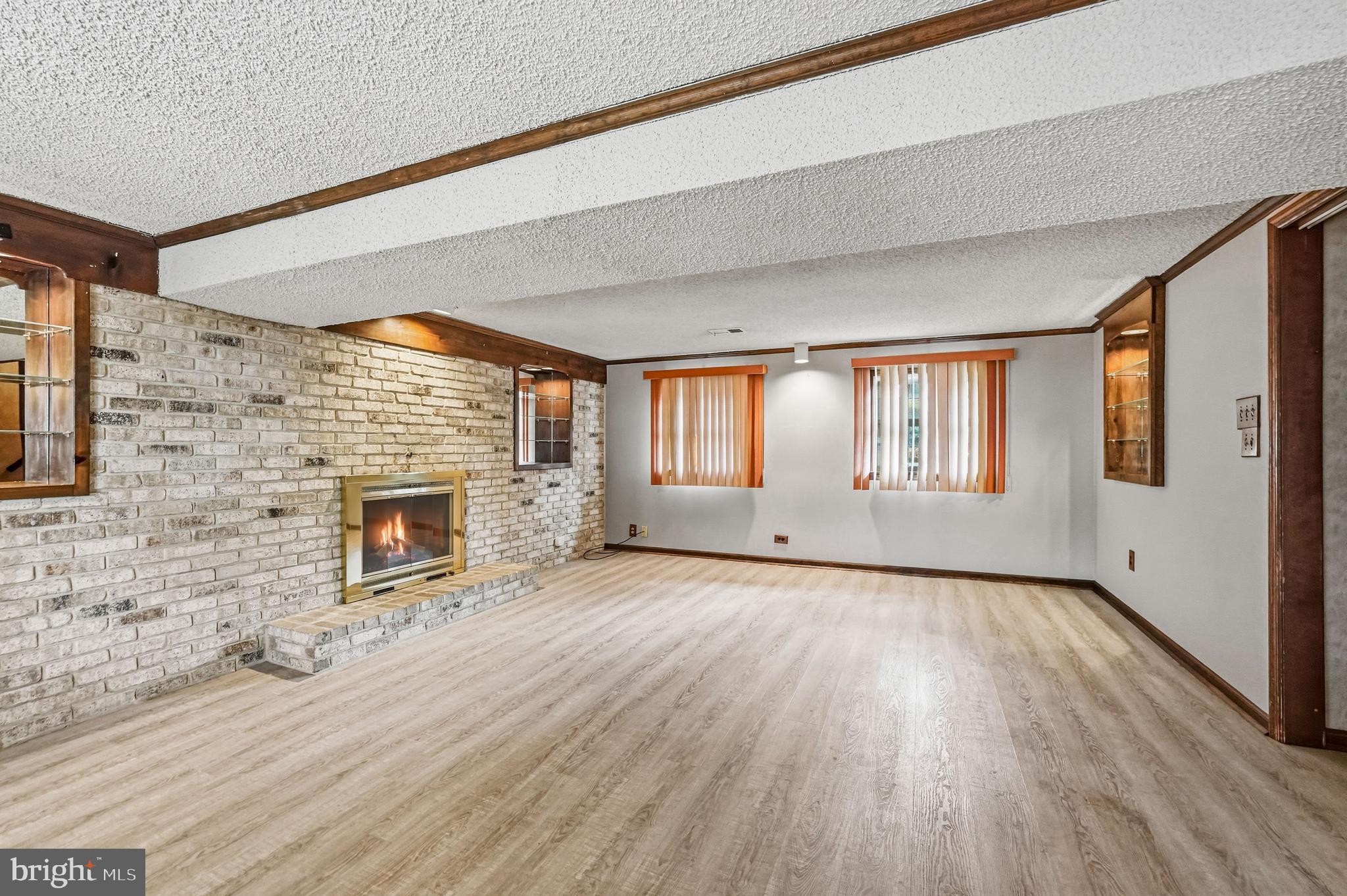 2 Winding Way Berlin, NJ 08009 - Photo 24 of 31 a view of empty room with wooden floor and fireplace