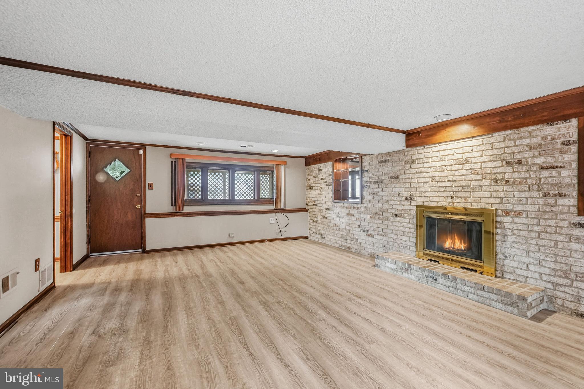 2 Winding Way Berlin, NJ 08009 - Photo 25 of 31 wooden floor fireplace and windows in an empty room