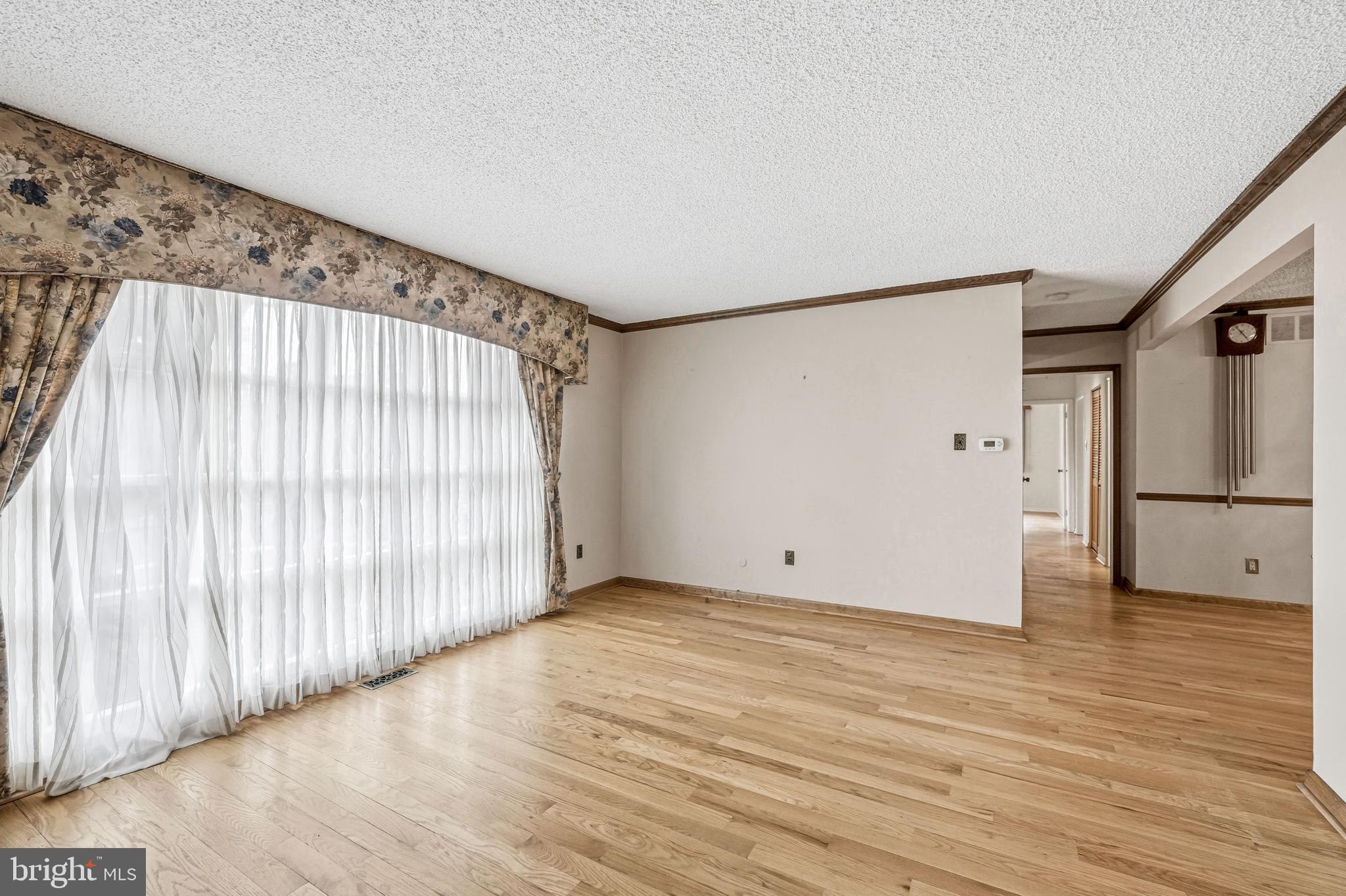 2 Winding Way Berlin, NJ 08009 - Photo 6 of 31 a view of an empty room with wooden floor and a window