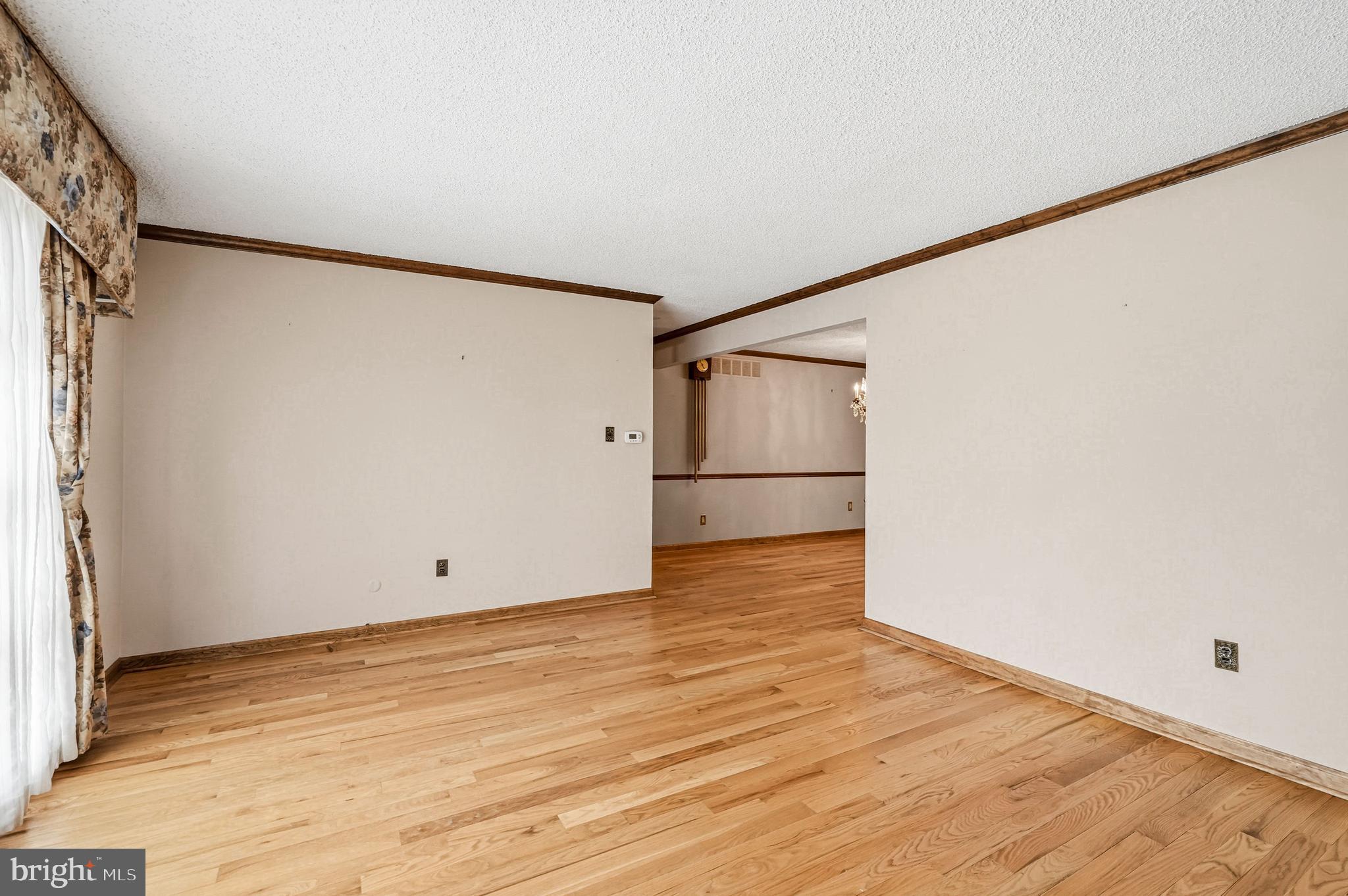 2 Winding Way Berlin, NJ 08009 - Photo 7 of 31 a view of an empty room with wooden floor and a refrigerator